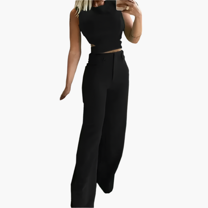 Modernt kvinnors set med stilren crop top och flödande vida byxor. Mångsidig, elegant för sommar & fest.
