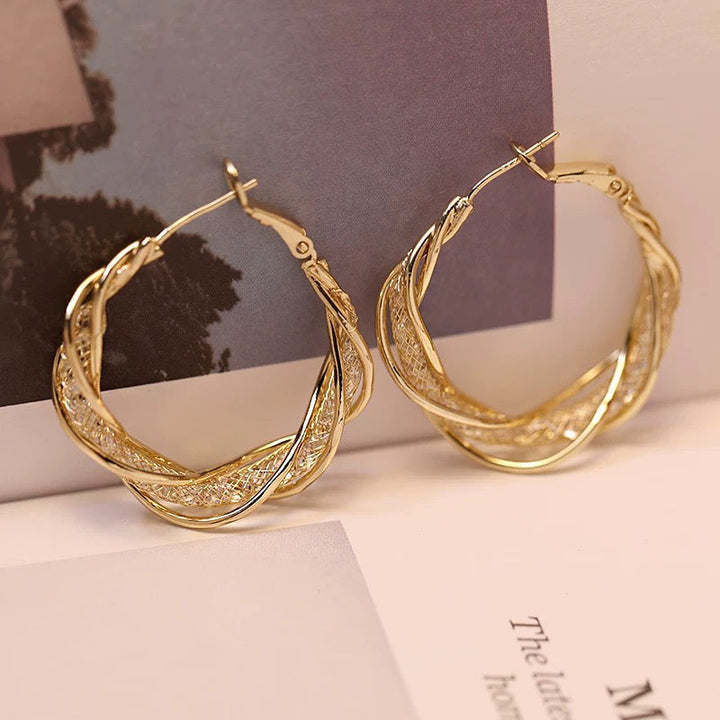 Elegant twistörhängen för kvinnor i guld och silver, geometrisk design, perfekt accessoar för alla tillfällen.