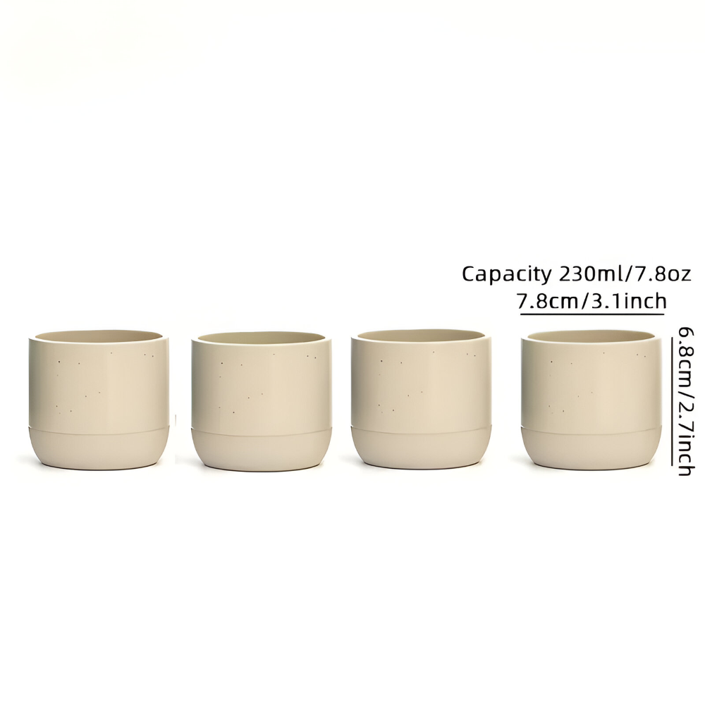 Elegant keramik kaffekopp bredvid en bok. 4-pack muggar för avkoppling. Ett fint muggset.