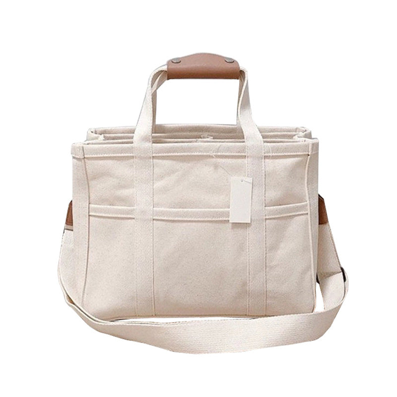 "Enfärgad dam tygkasse i robust canvas, med breda handtag och stor kapacitet. Perfekt som chic och hållbar väska."