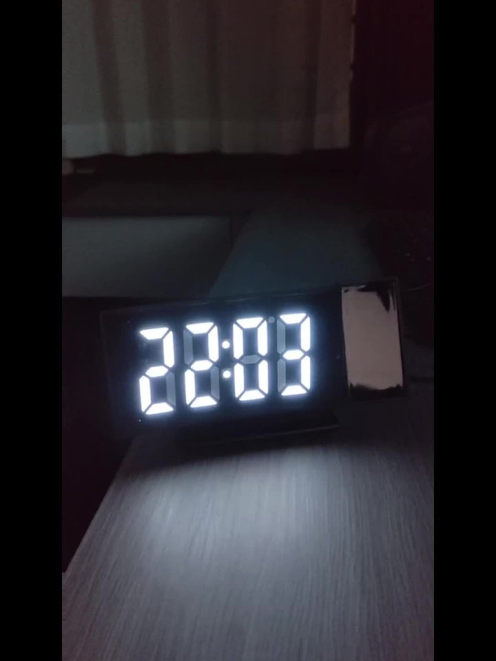 Digital väckarklocka med upplyst LED-display i mörker