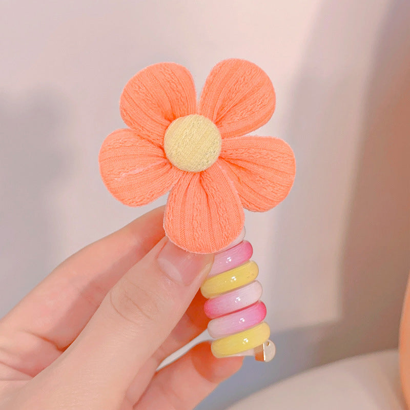 "Färgglada, elastiska hårband för barn med tecknade motiv och blommönster i flera färger, perfekta för daglig användning."