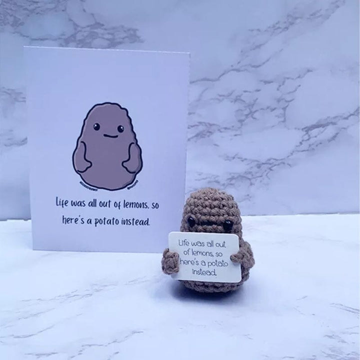 Färgglad stickad positiv potatisdocka med uttrycksfulla detaljer, en rolig julklapp.