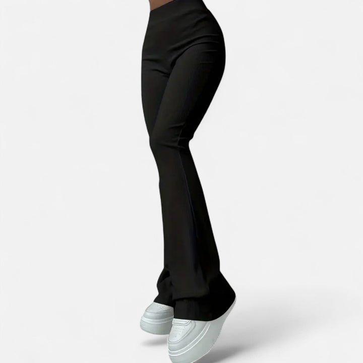 Damens svarta högmidjade ribbade slim leggings sedda från sidan
