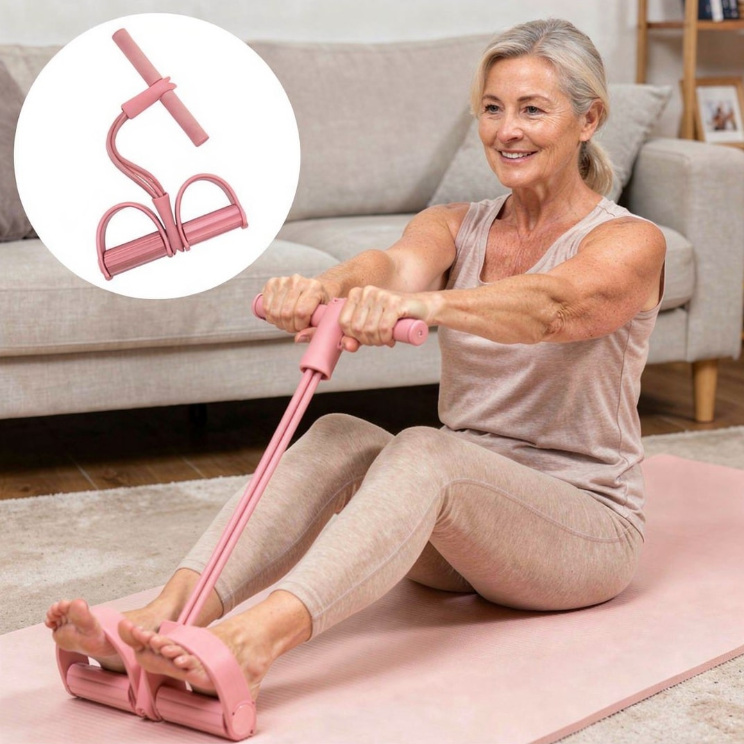 Rosa fitnessband placerat på trägolv för stretching och övningar