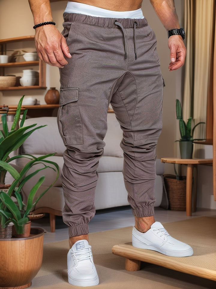 Man iklädd grå cargo joggers med elastisk midja och sidofickor
