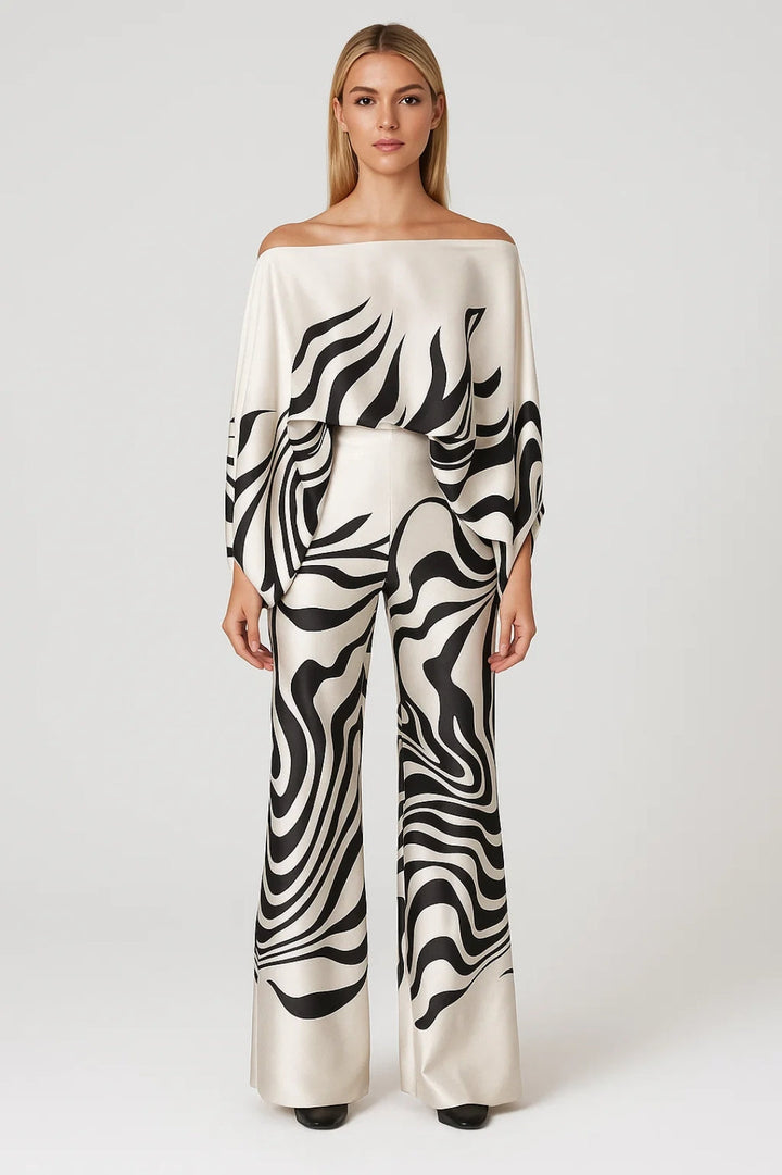 Modell bär svart-vitt mönstrat damset med off shoulder-topp