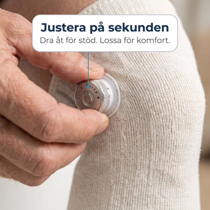 Närbild på person som justerar kompressionen på Zvarelo knästöd med vridknopp
