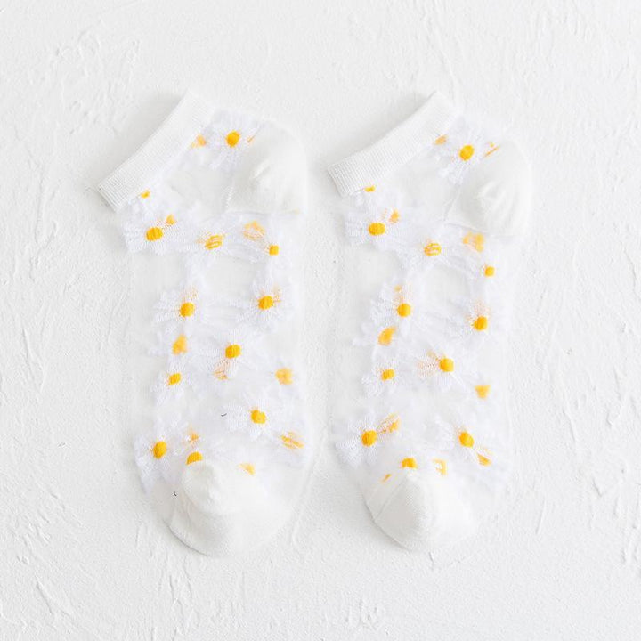 Genomskinliga damsockor med blommotiv, feminin design med spets- och blomdetaljer, perfekt för sommaroutfits.