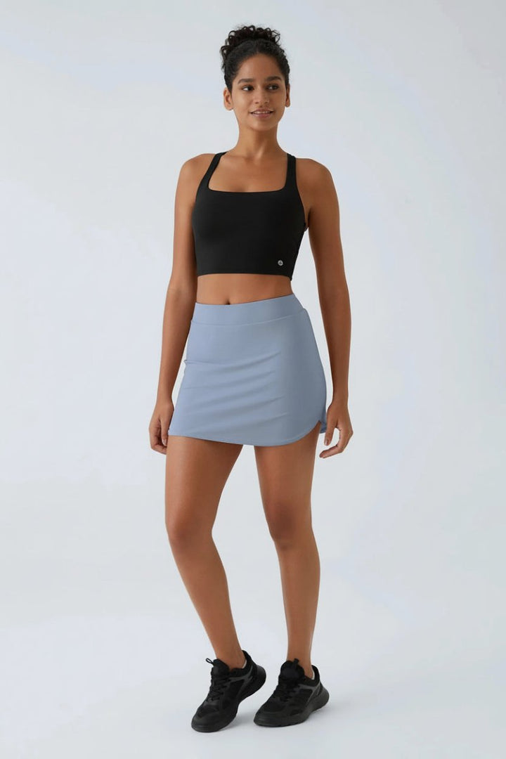 Grön dam sportskort mini i Ivy, perfekt för träning och aktivitet.