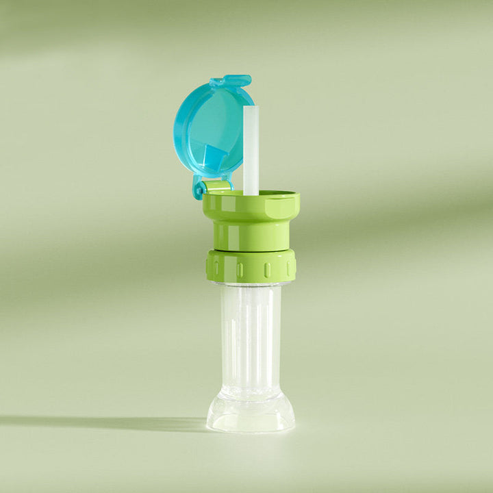 "Grönt portabelt flasklock med sugrör, perfekt för barn och vuxna, enkel design, passar små och stora flaskor."