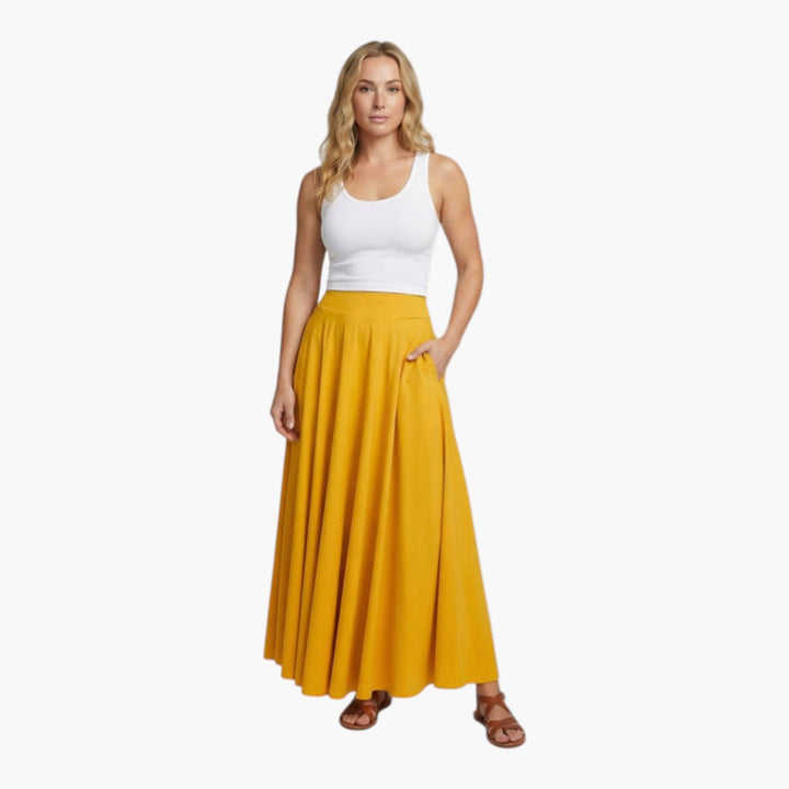 Gul lång maxikjol för kvinnor, högmidjad med brett midjeband och praktiska fickor. Elegant utsvängd vardags- och festkjol.