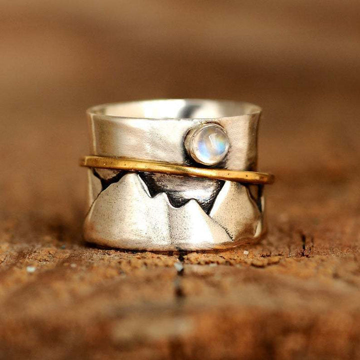 Guldfärgad damring med måne och berg, elegant accessoar med naturtema