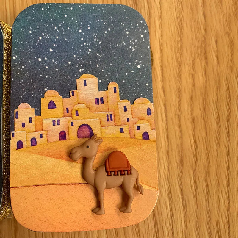 "Handgjord julkrubba med figurer som Maria, Josef, Jesus under stjärnklar natt, perfekt för festlig dekoration."