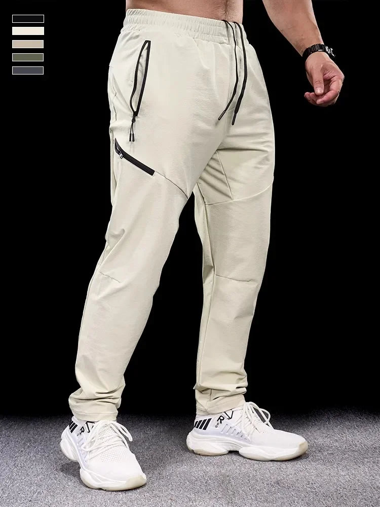 Man iklädd aprikosfärgat par tapered joggingbyxor med dragkedjefickor