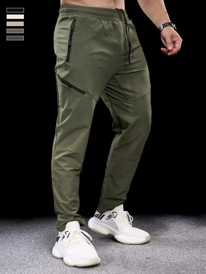 Grå herr joggingbyxor tapered sport med dragkedjefickor för träning