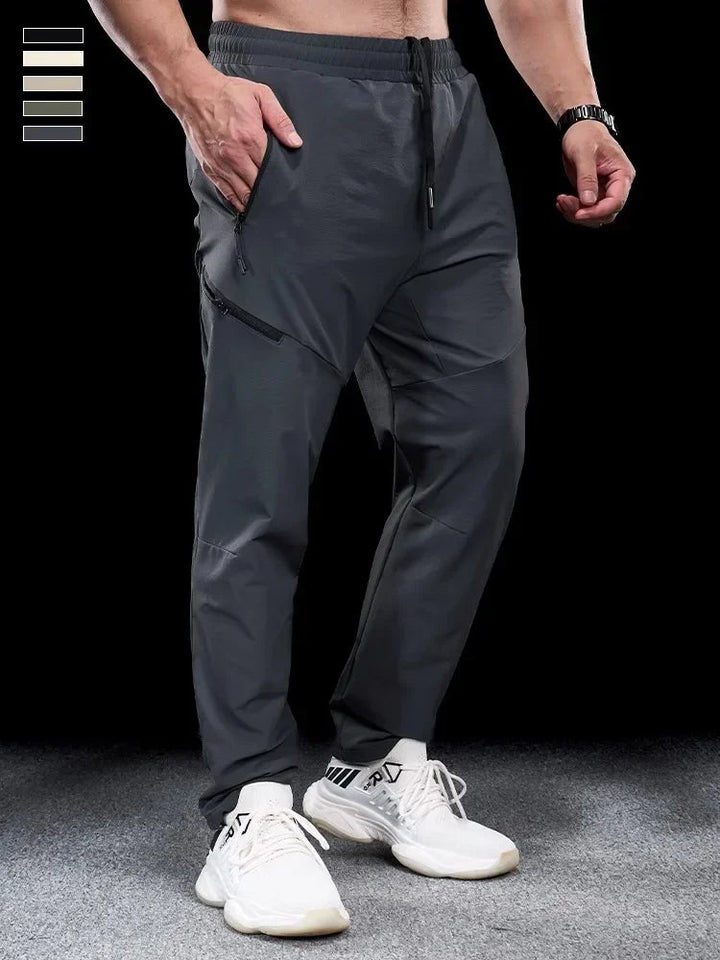 Man iklädd gråa sportiga joggingbyxor för herr med elastisk midja