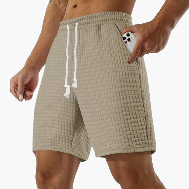 Herrshorts med dragsko, elastisk midja & fickor, perfekta för fritid & sommar.