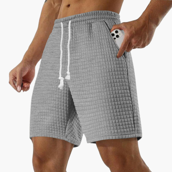 Stilrena herrshorts med dragsko & fickor, utmärkta som fritidsshorts & sommarshorts för män.