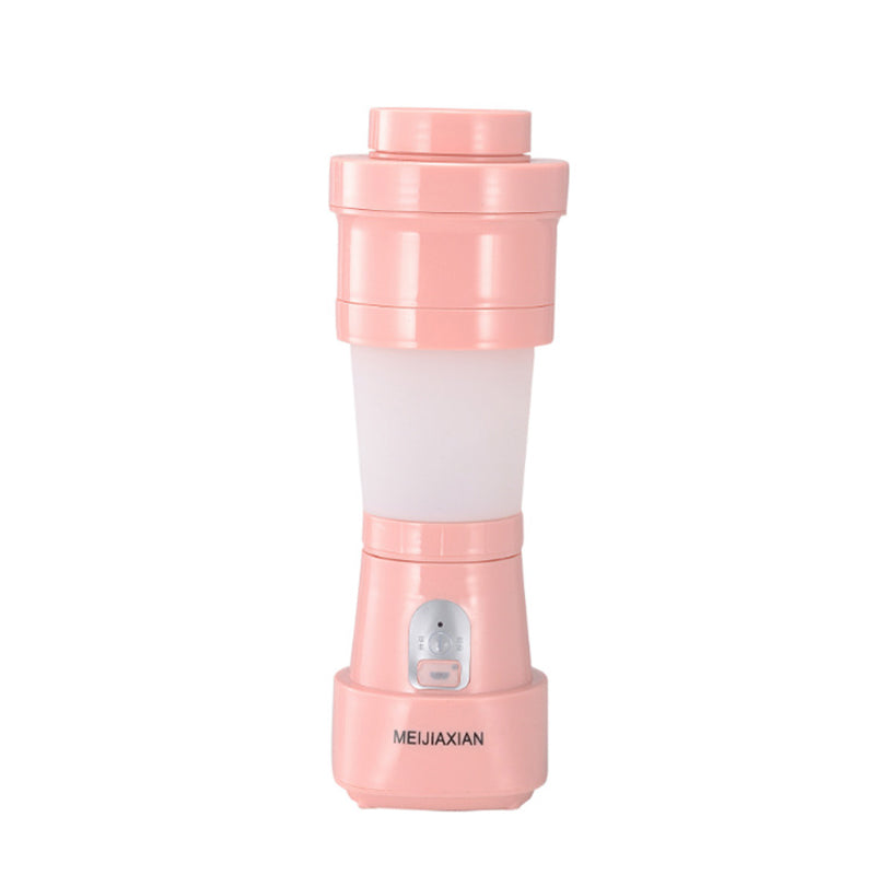"Hopfällbar mini-juicepresskopp i rosa, kompakt design med rostfritt stålblad, idealisk för hälsosamma drycker på språng."