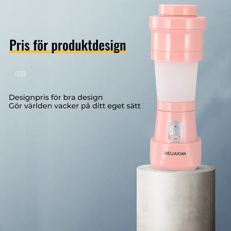 "Hopfällbar mini-juicepresskopp i rosa, kompakt design med rostfritt stålblad, idealisk för hälsosamma drycker på språng."