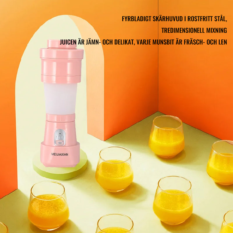 "Hopfällbar mini-juicepresskopp i rosa, kompakt design med rostfritt stålblad, idealisk för hälsosamma drycker på språng."