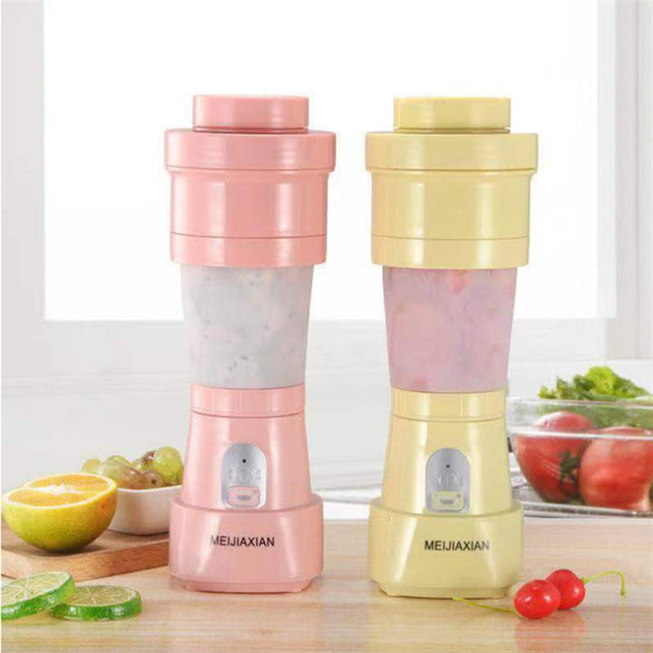 "Hopfällbar mini-juicepresskopp i rosa, kompakt design med rostfritt stålblad, idealisk för hälsosamma drycker på språng."