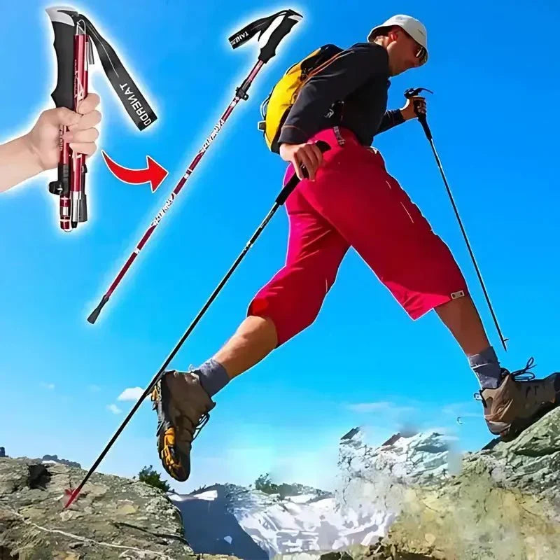 Närbild på person som fäller ihop en röd vandringsstav