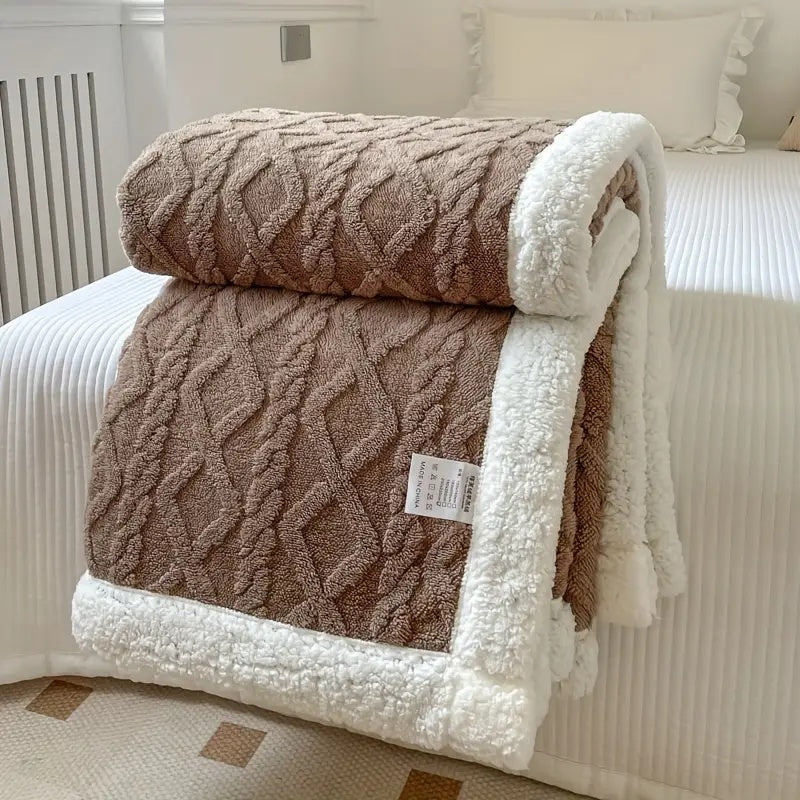 Närbild på den fluffiga sherpatexturen hos en mysig vinterfilt