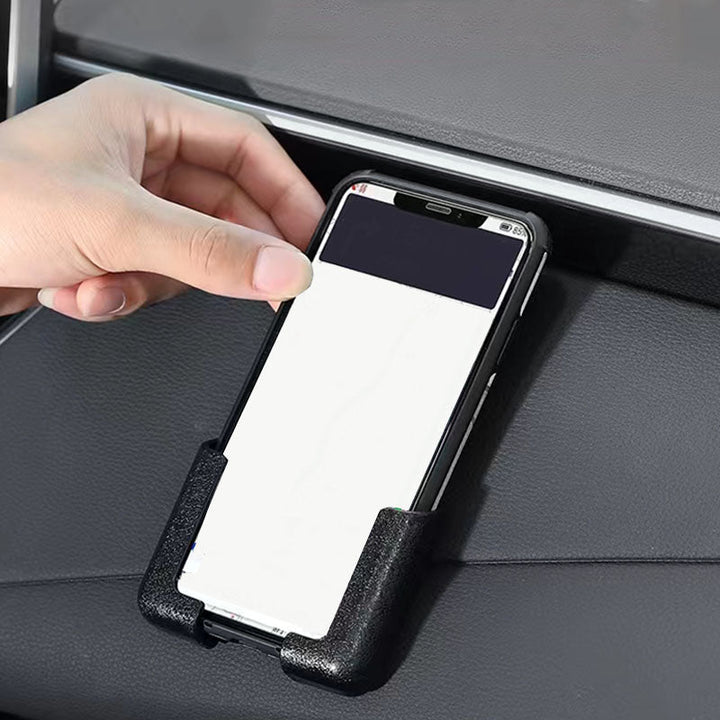 Justerbar biltelefonhållare för instrumentbräda i svart/glad färg, självhäftande bas, hållbar och stötsäker design.