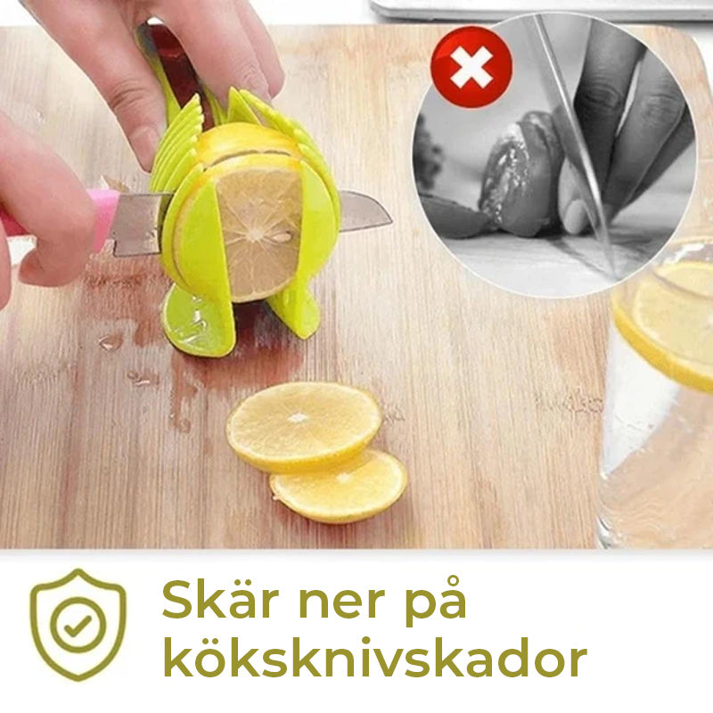 Köksverktyg för snabb slicing i grön och svart ABS-plast, med ergonomiska handtag, för säker och snabb skärning av frukt och grönsaker.