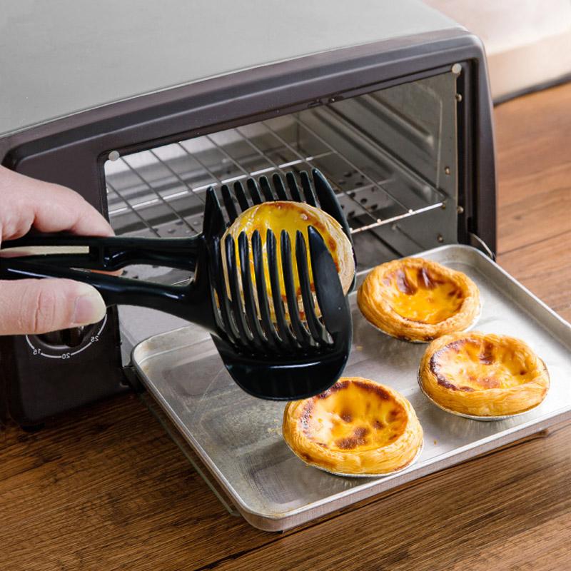 Köksverktyg för snabb slicing i grön och svart ABS-plast, med ergonomiska handtag, för säker och snabb skärning av frukt och grönsaker.