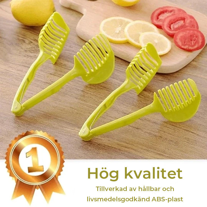 Köksverktyg för snabb slicing i grön och svart ABS-plast, med ergonomiska handtag, för säker och snabb skärning av frukt och grönsaker.