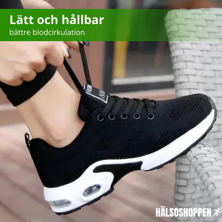 Detaljbild av andningsbart material på lätta damsneakers, designade för komfort och stil.