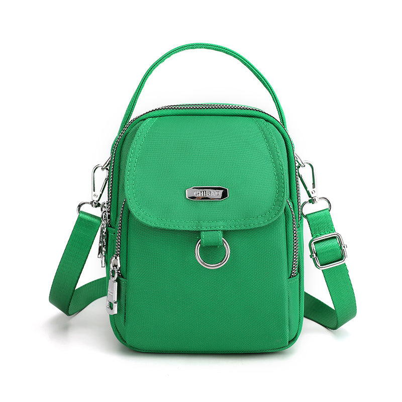 "Lätt vattentät unisex crossbody-väska i nylon med flera fickor, justerbar axelrem, kompakt och funktionell design"