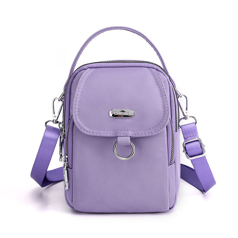 "Lätt vattentät unisex crossbody-väska i nylon med flera fickor, justerbar axelrem, kompakt och funktionell design"