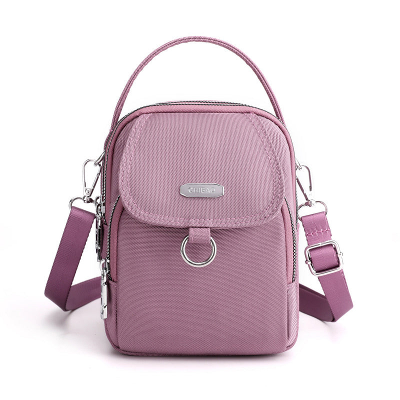 "Lätt vattentät unisex crossbody-väska i nylon med flera fickor, justerbar axelrem, kompakt och funktionell design"