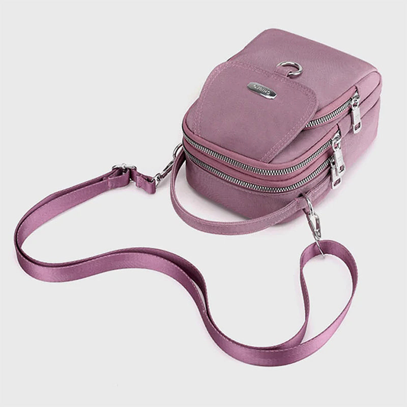 "Lätt vattentät unisex crossbody-väska i nylon med flera fickor, justerbar axelrem, kompakt och funktionell design"