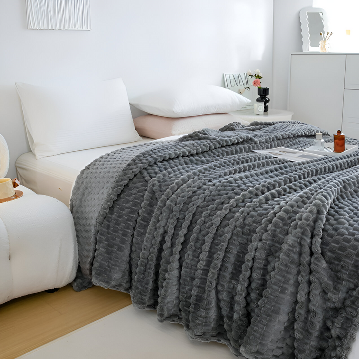 Mjuk fleecefilt i plysch. Bekväm sofffilt för vardagsrummet, värmande hemtextil för kalla kvällar.