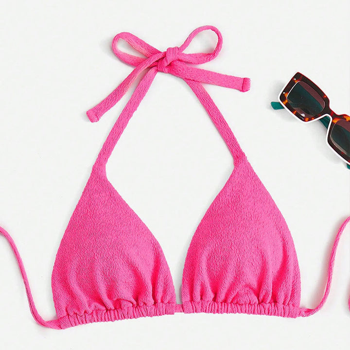 Trendig bikiniöverdel i magenta med omlottdesign. Justerbara axelband ger optimal komfort för damers badkläder.