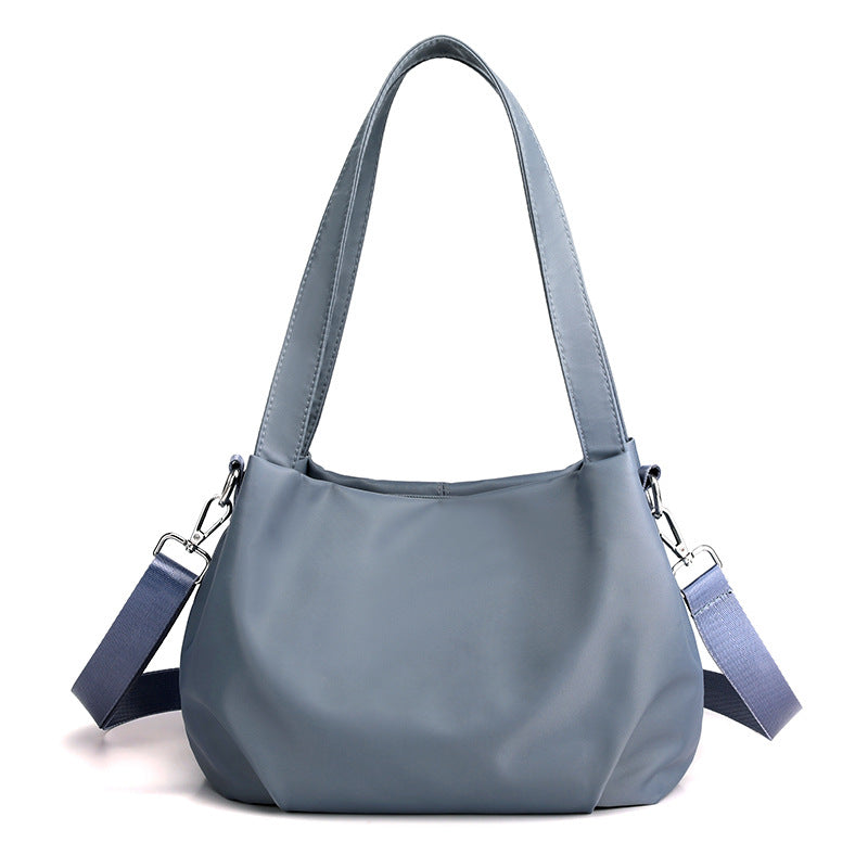 "Mångsidig nylon crossbody väska för kvinnor med ficka, justerbar rem och fler färgval, perfekt för vardag och resor."