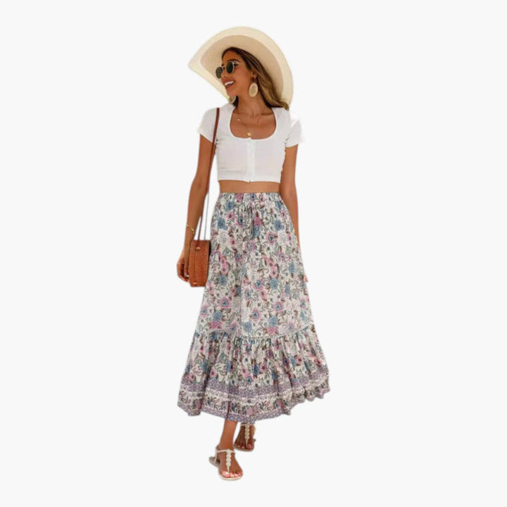 Midi-kjol för kvinnor med elastisk midja, blommigt tryck och eleganta volangpaneler, perfekt för sommar.