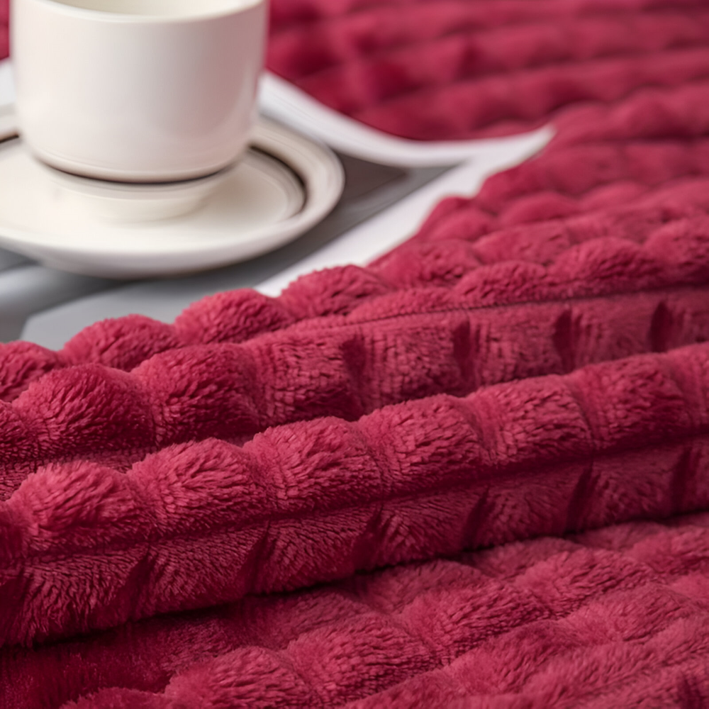 Varm rutig pläd av korallfleece. Mysig och mjuk filt för soffan eller sängen.