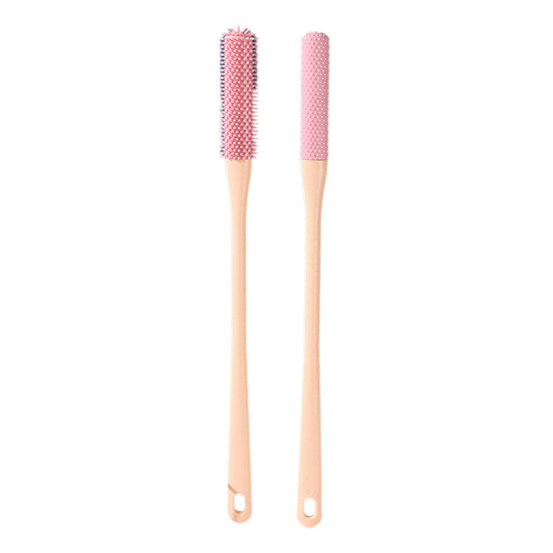 Mjuk grå ergonomisk tåborste med skonsamma borst, perfekt för effektiv fotvård.