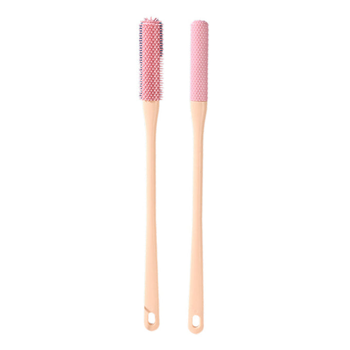 Mjuk grå ergonomisk tåborste med skonsamma borst, perfekt för effektiv fotvård.