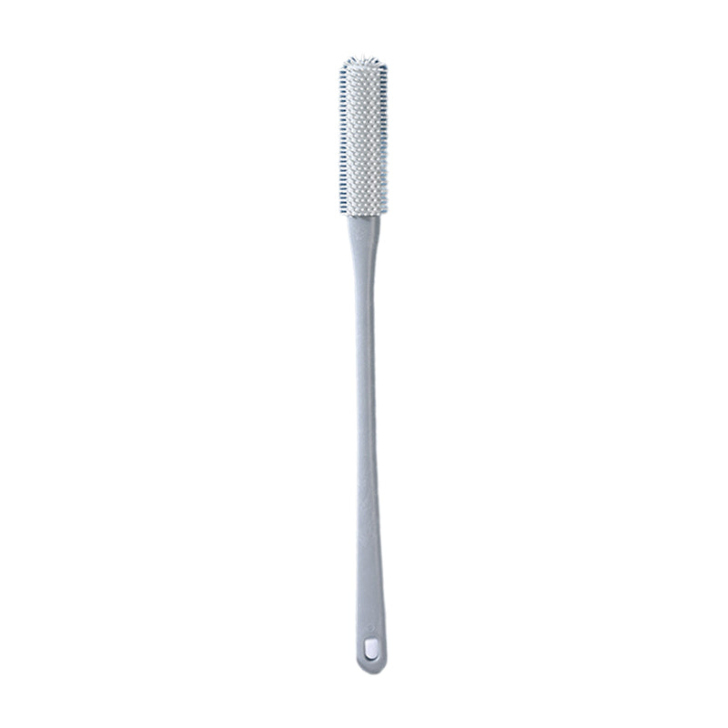 Mjuk grå ergonomisk tåborste med skonsamma borst, perfekt för effektiv fotvård.