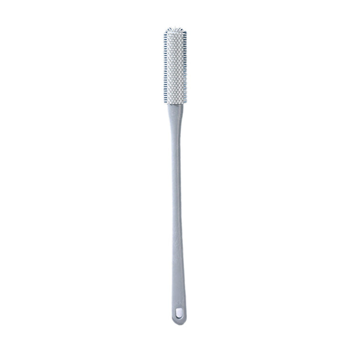 Mjuk grå ergonomisk tåborste med skonsamma borst, perfekt för effektiv fotvård.
