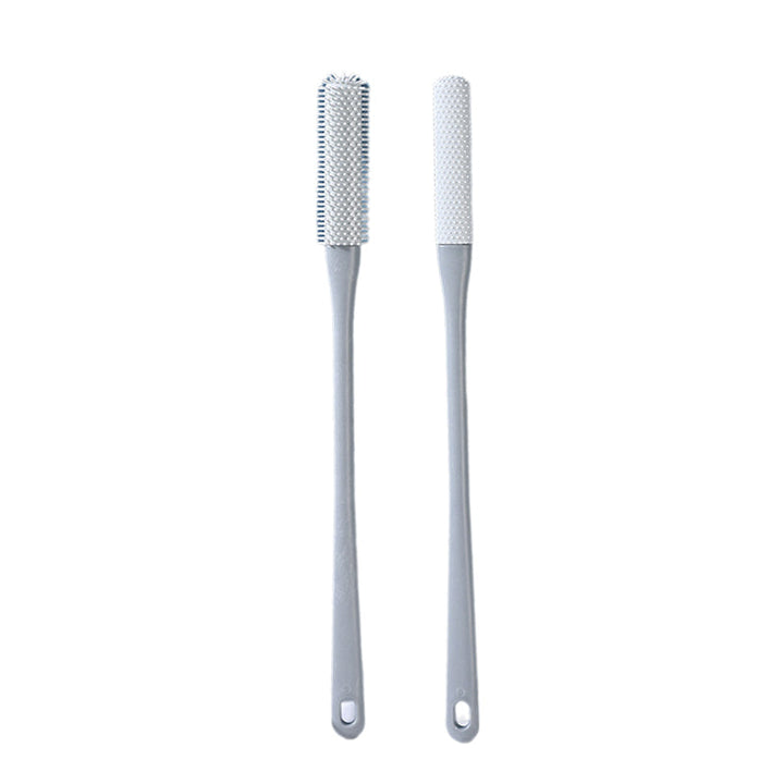 Mjuk grå ergonomisk tåborste med skonsamma borst, perfekt för effektiv fotvård.