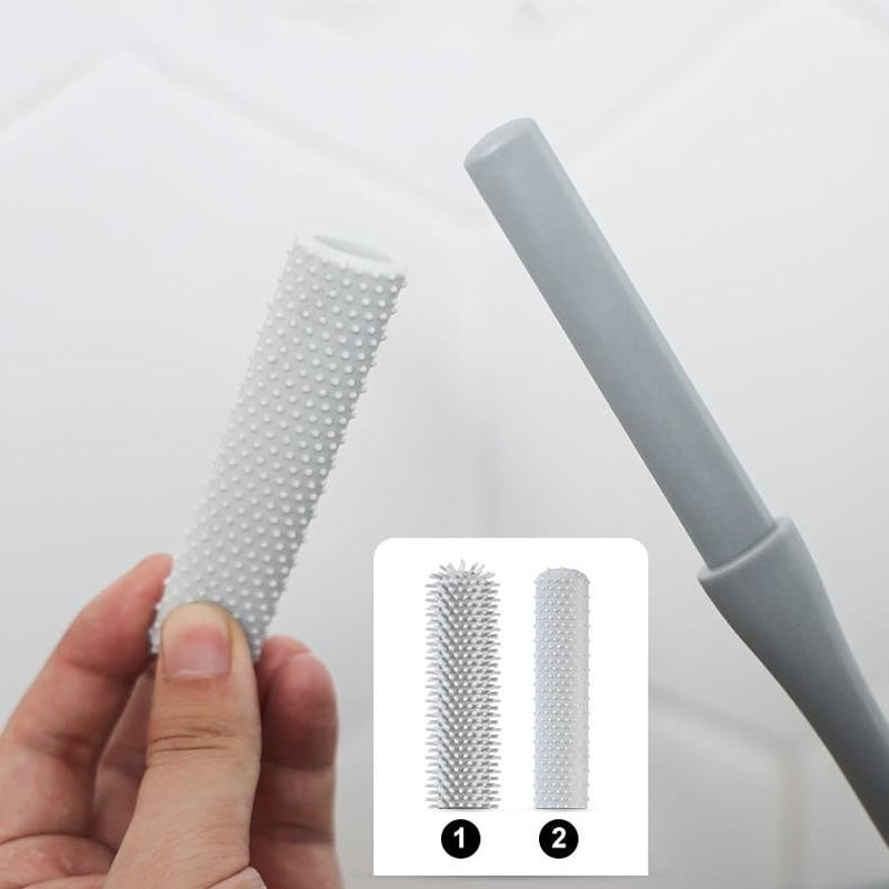 Mjuk grå ergonomisk tåborste med skonsamma borst, perfekt för effektiv fotvård.