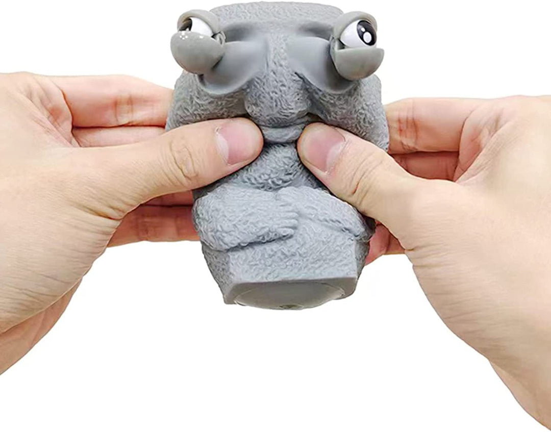 Moai LED stressleksak med utstickande ögon, grå/brun färg, kompakt design, perfekt för stressavlastning och dekoration.
